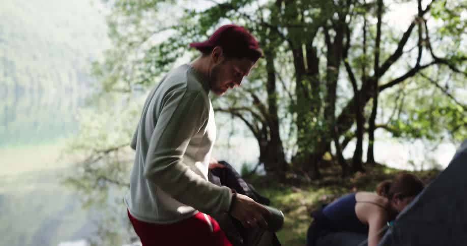 Two people setting up a tent