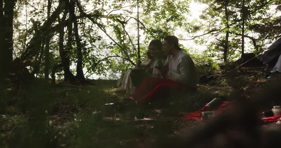 Man and woman are camping in the forest in spring