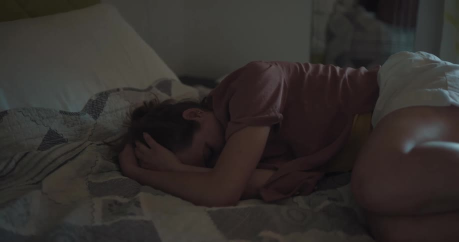 Woman crying in bed