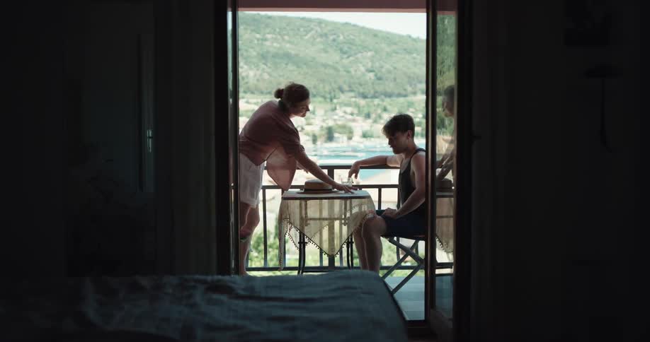 Young couple on vacation arguing on the balcony outside the bedroom