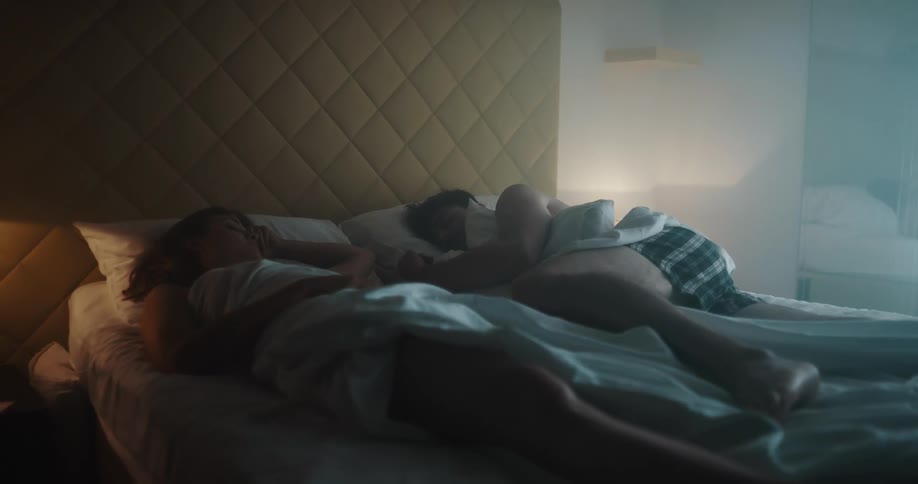 Man with boxer shorts and woman sleep in bed at night