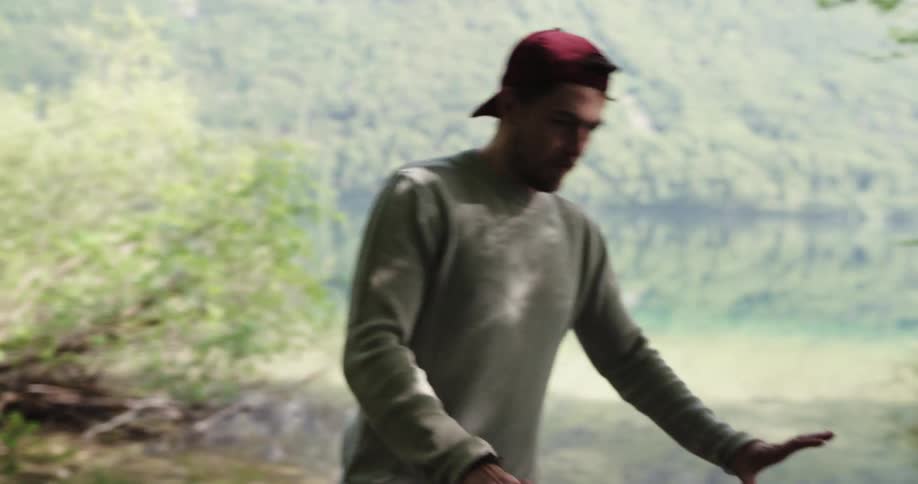 Two people are setting up a tent in the mountains