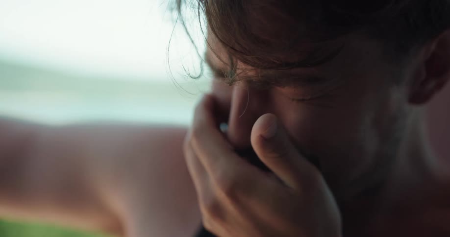 Man crying and drinking