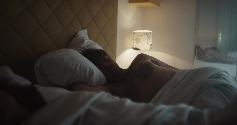 A man and woman sleeping in a bed