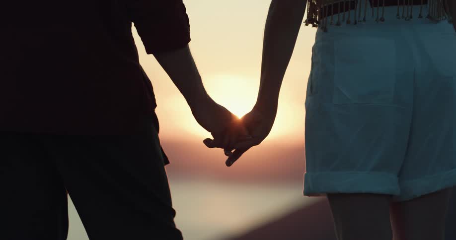 A boyfriend and girlfriend holding hands
