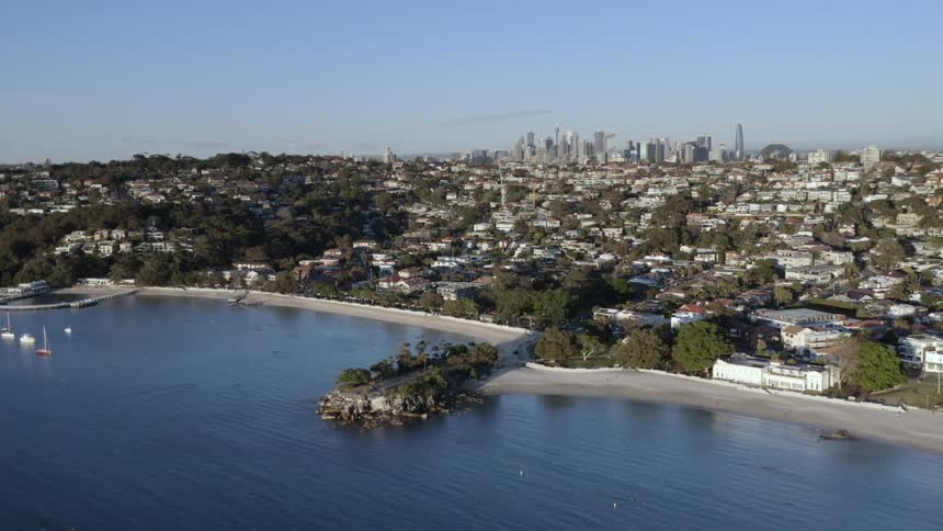 Aerial view of a city near a beach is displayed in spring