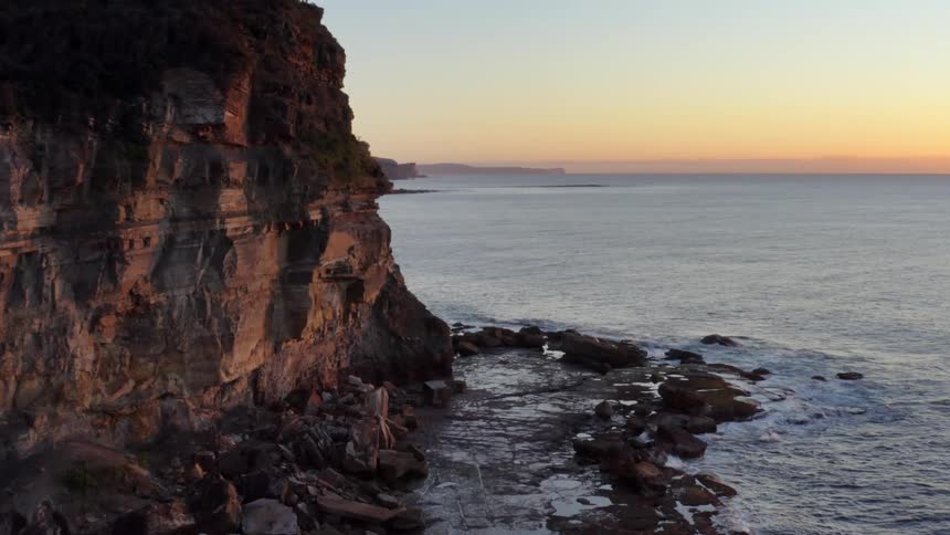 An aerial view of cliffs that are near the ocean