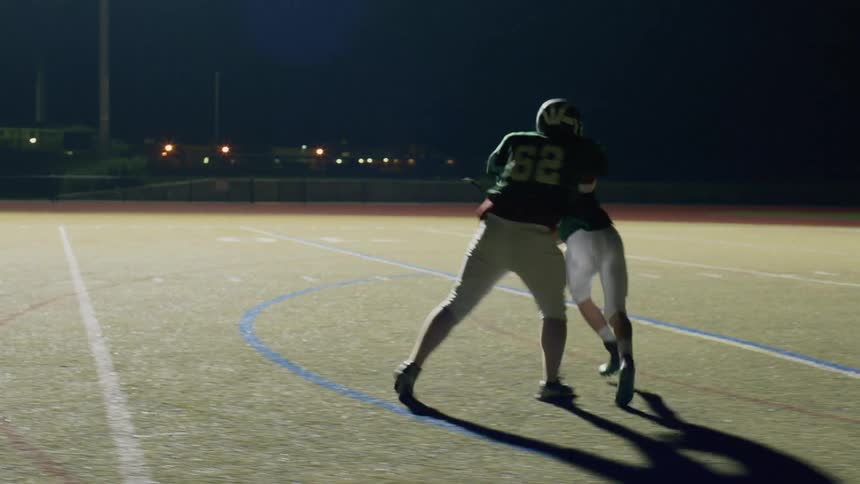 Group of football players practicing on a field