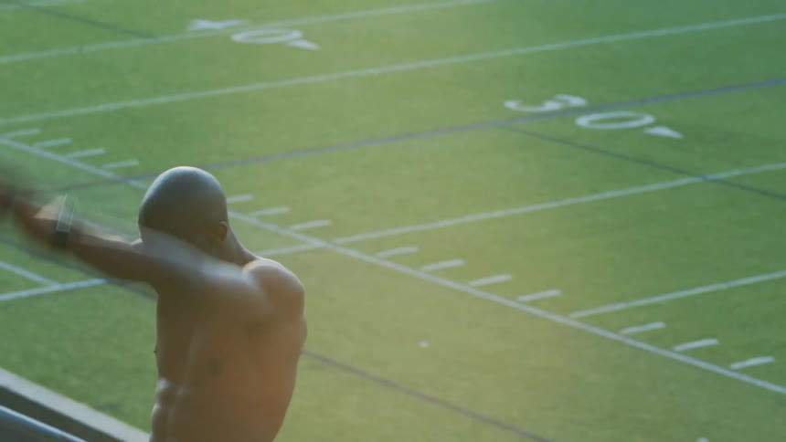 Man exercising in an empty stadium in the daytime