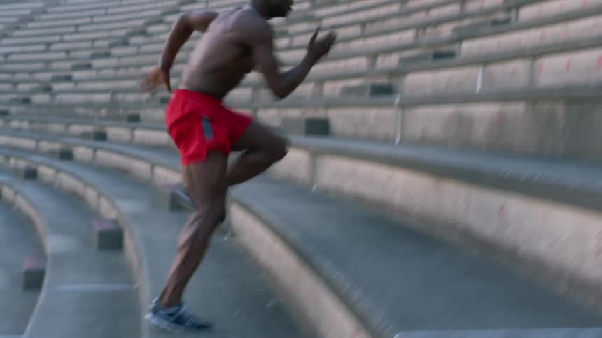 A person running up stadium stairs