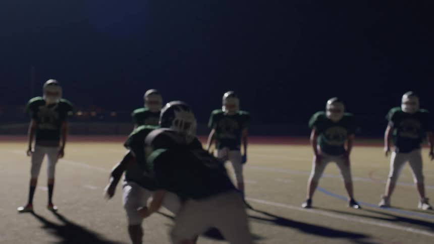 Football players practicing on the field