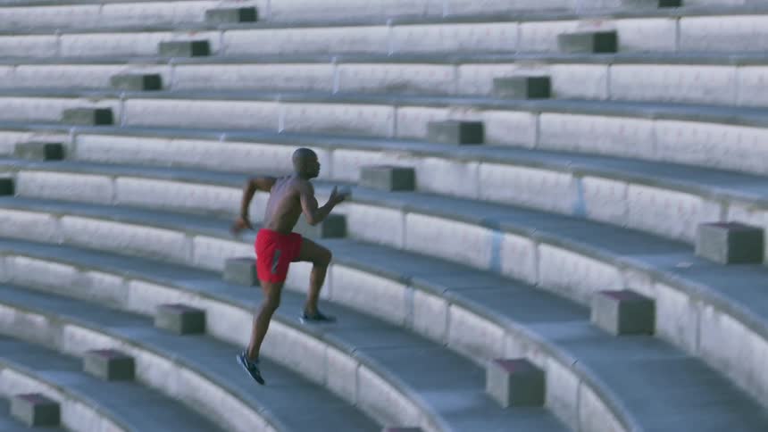 A man sprints up bleachers