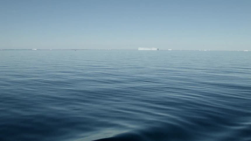 Water rolls under a clear sky