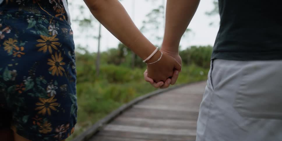 Man and female holding hands