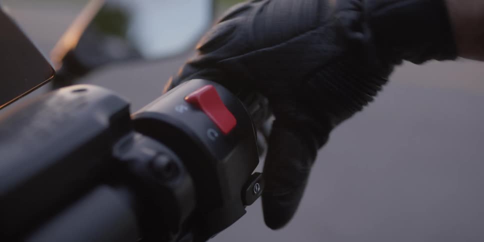 A person that is turning a throttle on a motorcycle