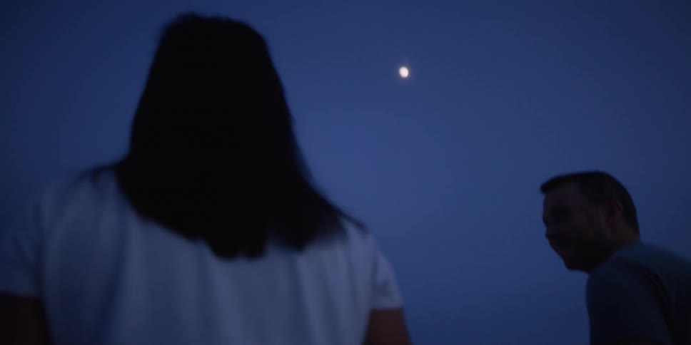 A man and woman are walking together at night