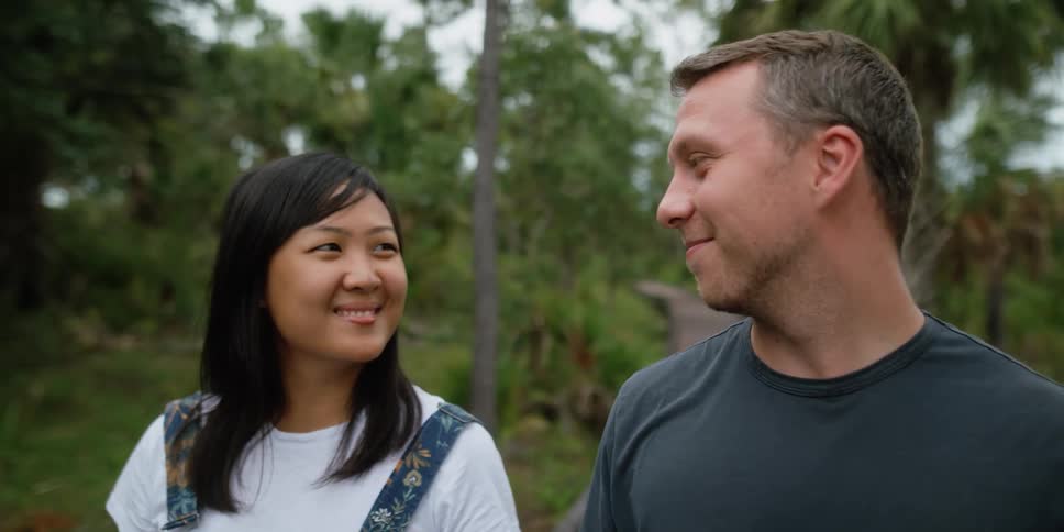 A man and woman talking to each other and smiling