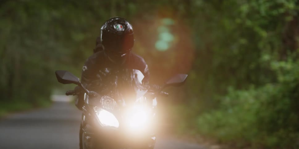 A person rides a motorcycle on a rural road
