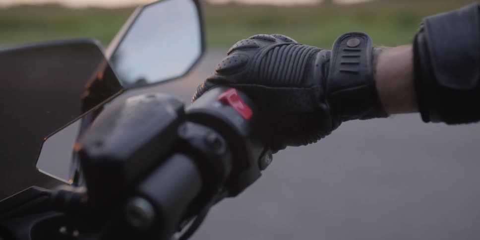 A man is on a parked motorcycle
