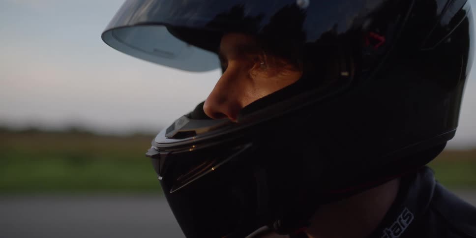 A man wearing a helmet looking into the distance