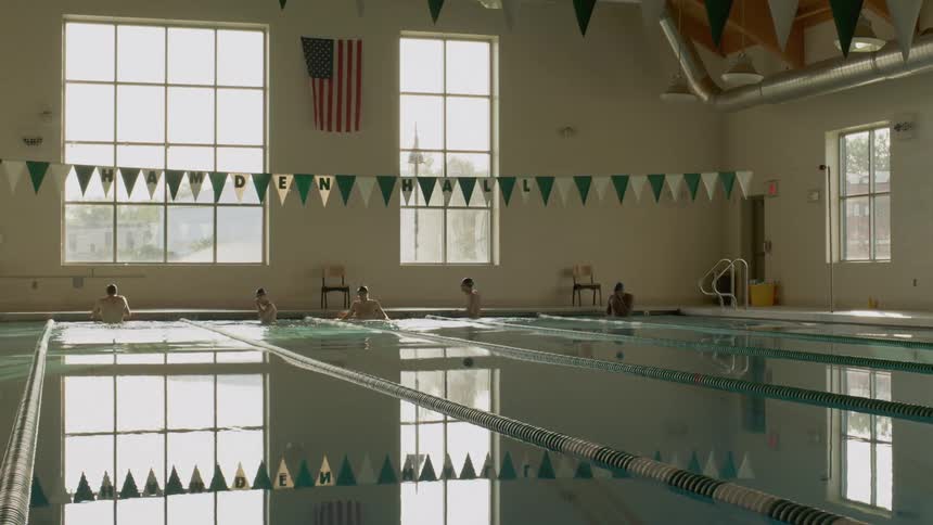 Swimmers getting ready in the pool for a race