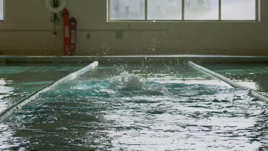 Person swimming laps in an indoor pool