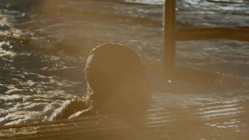 People are swimming in a pool as a race