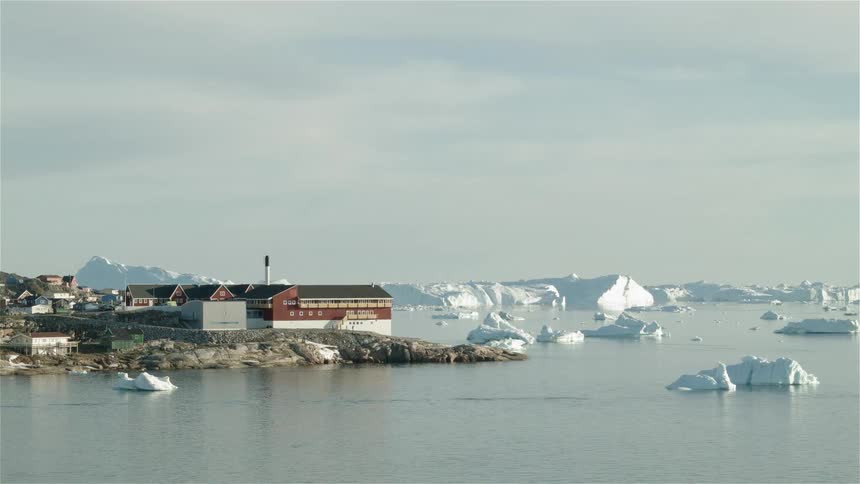 Icebergs float in the water near the coast