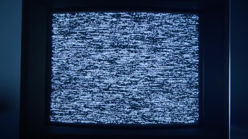 A television with flickering static screen while lights flash