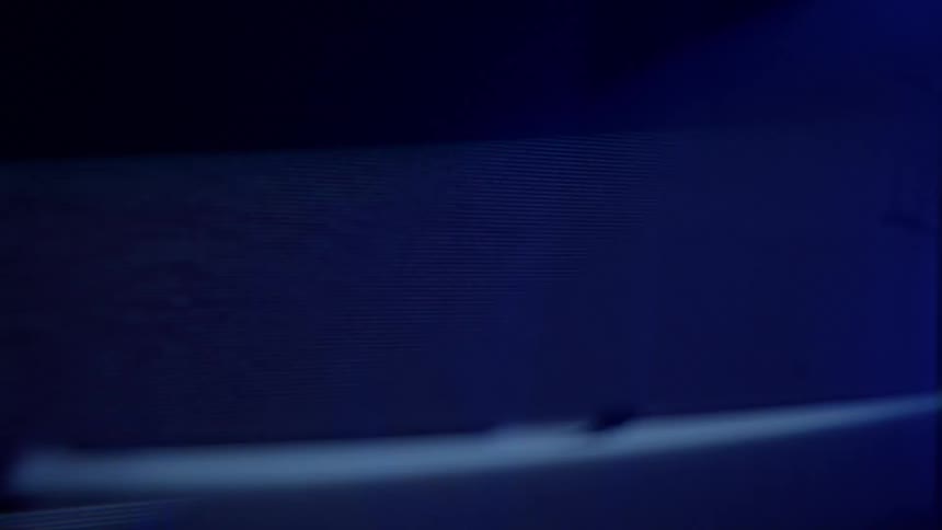 A dim screen flickers and shows lines of distortion and static