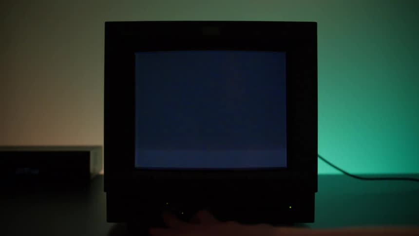 Static appears on television screen while colorful lights can be seen in the background