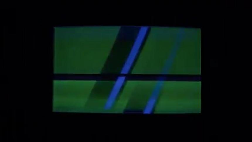 Dark flickering tv screen flashing inside a dimly lit room
