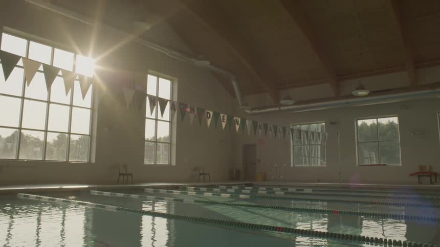 An indoor pool without swimmers and marked with race lanes