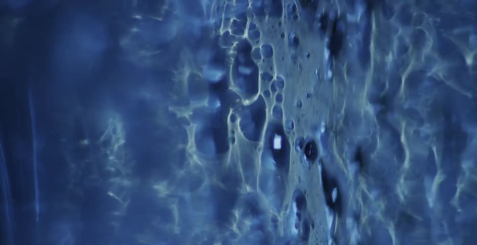 Falling blue liquid splashes