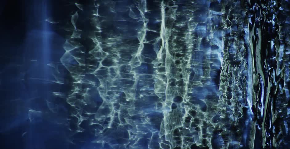 Water flows across a dark blue background