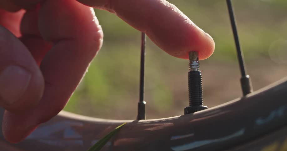 A close up of a bike valve releasing air