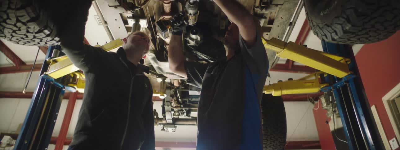 Two men working on a car