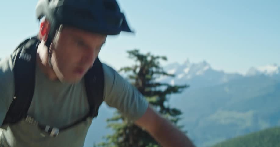 A man pedalling a bicycle up a steep mountain trail