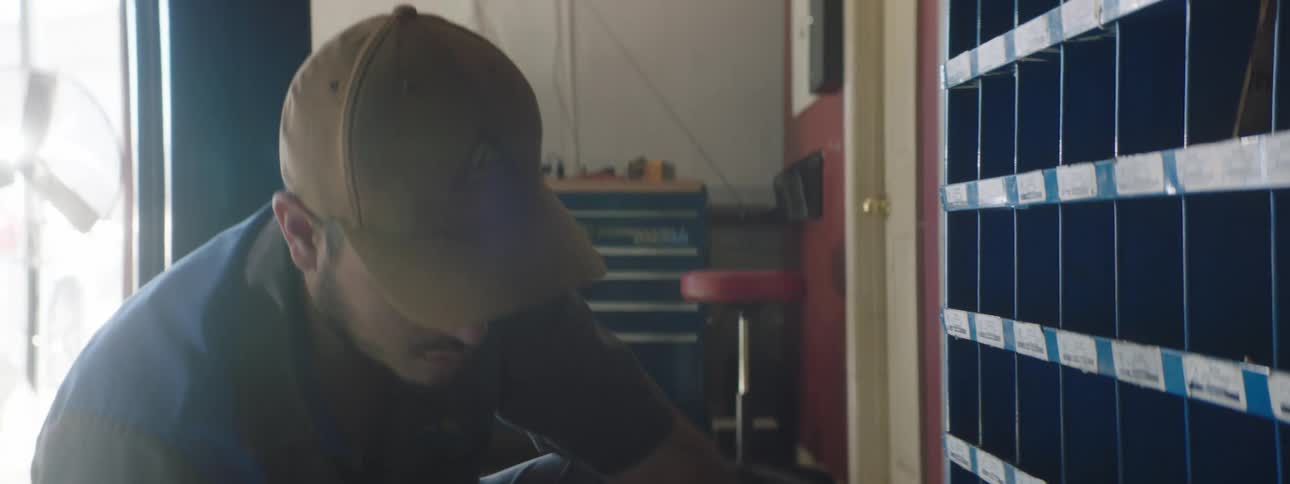 A man is working in a shop during the day