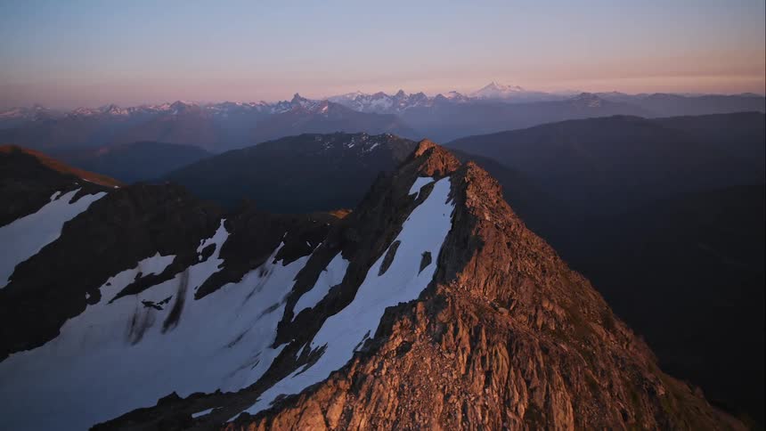 Aerial view of a rugged mountain ridge at sunset