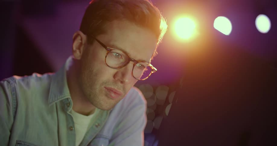 A man puts on his glasses to read something