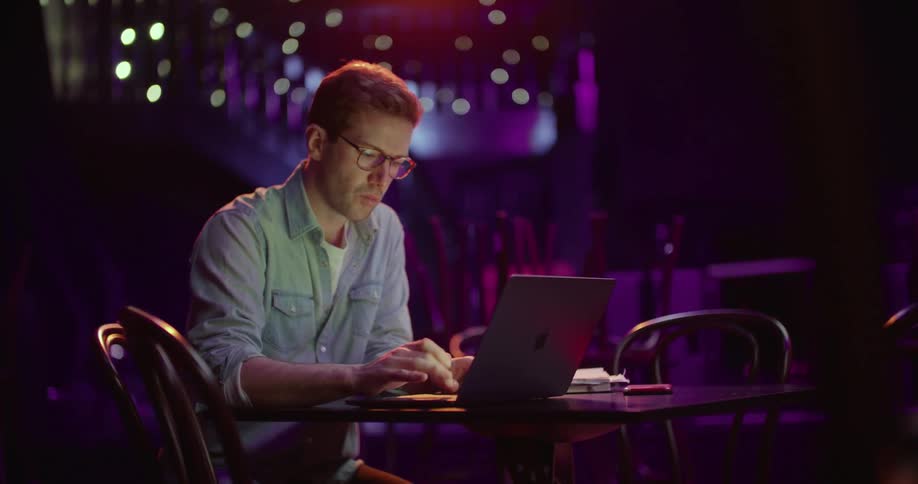 A man using a laptop in a club