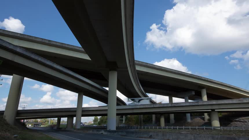 Vehicles move along a highway bridge system