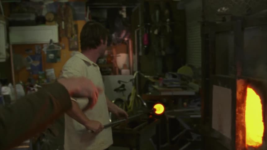A man removes glass from an oven