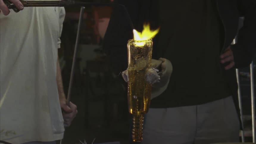 A man blows glass with a torch