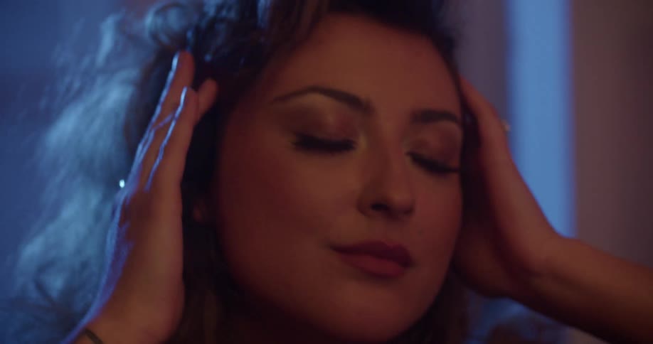 Woman dances as she listens to what is playing on her headphones