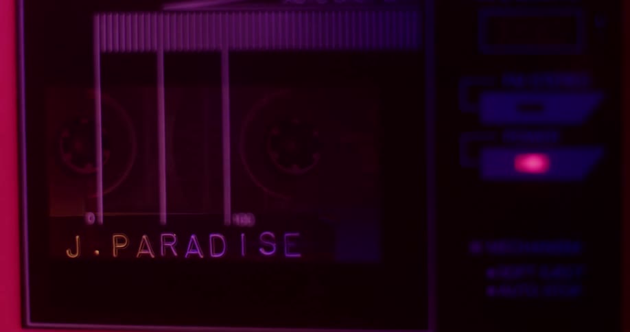 A cassette tape is placed in a boom box and starts to play