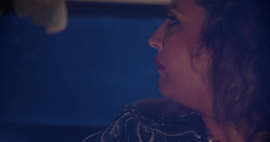 A woman driving a car and looking around