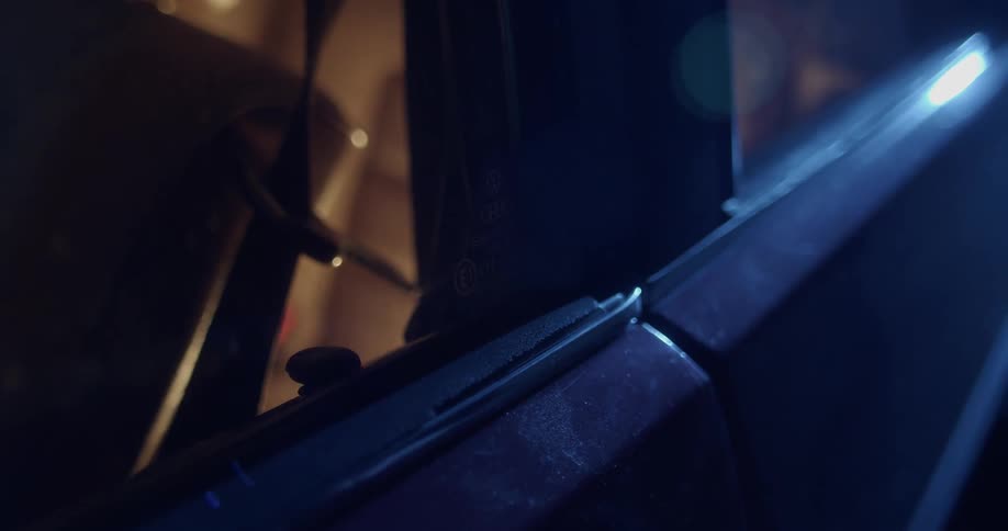 A person with a ring locking the door of a vehicle