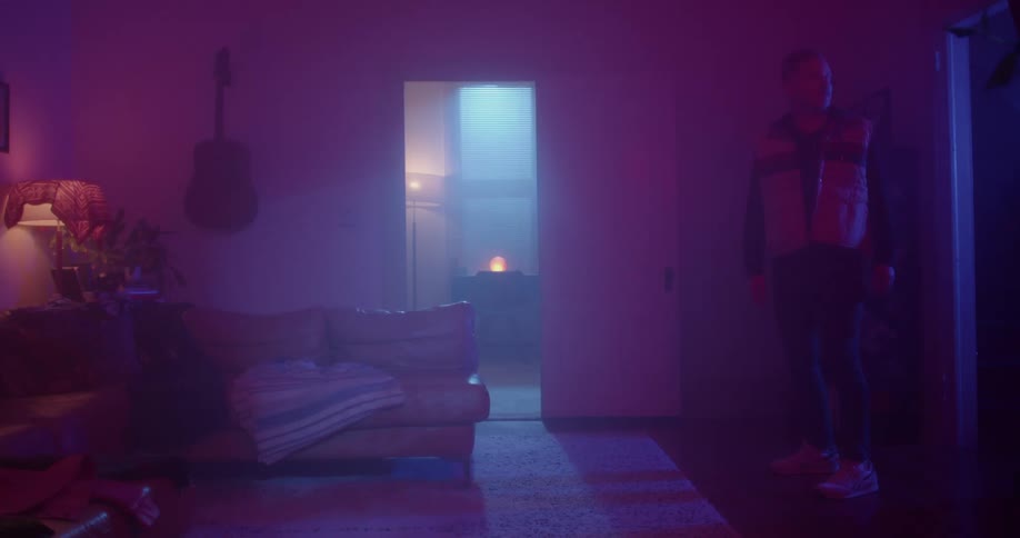 A man stands on the dark fog filled room